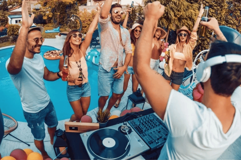 A DJ at a pool party getting the crowd excited.