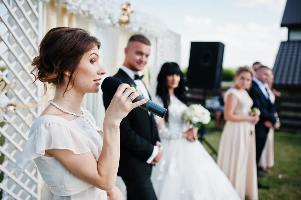 Bridesmaid giving speech at a wedding.