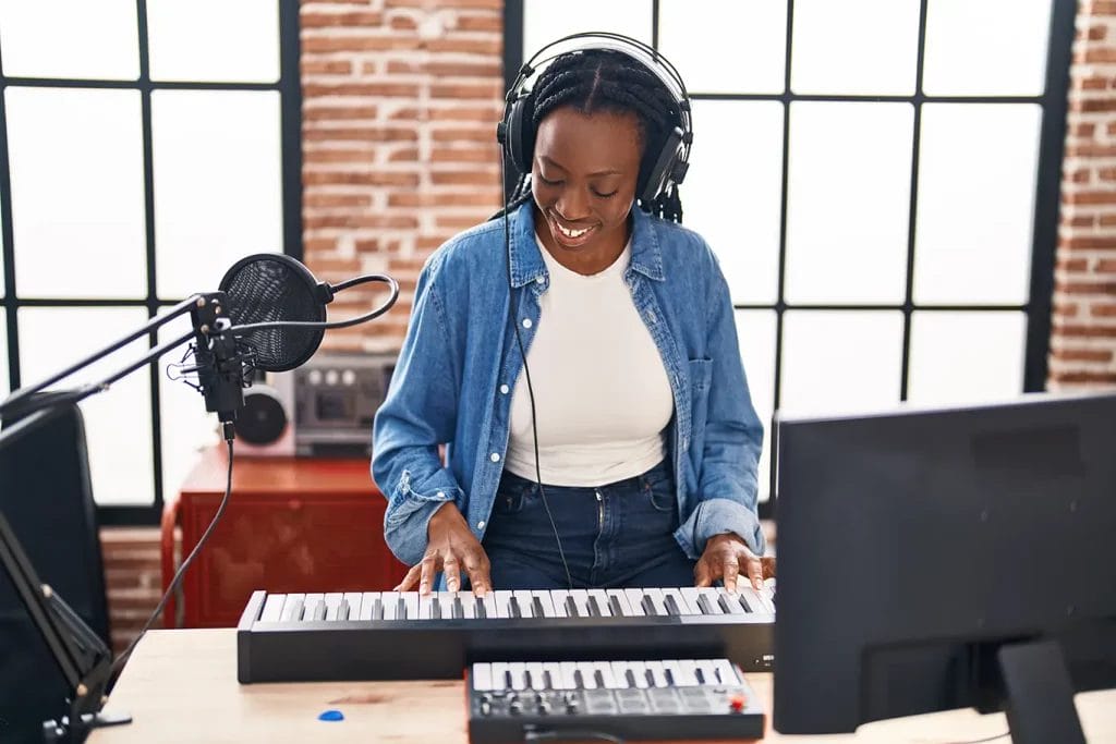 Musician at a keyboard playing.