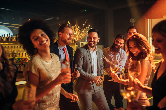 Holiday partygoers drinking cocktails.