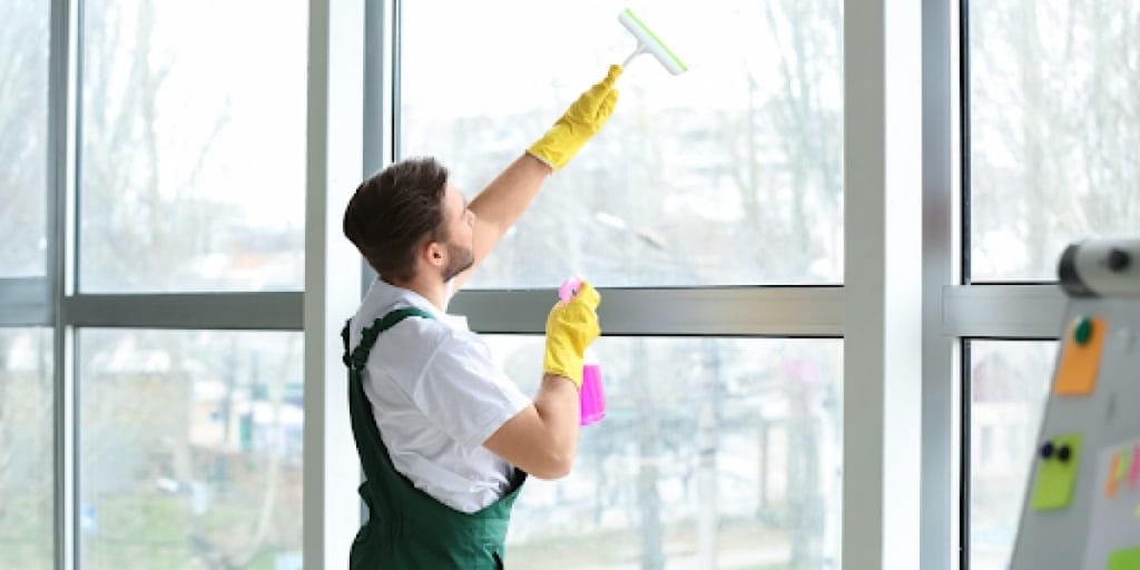 man cleaning window