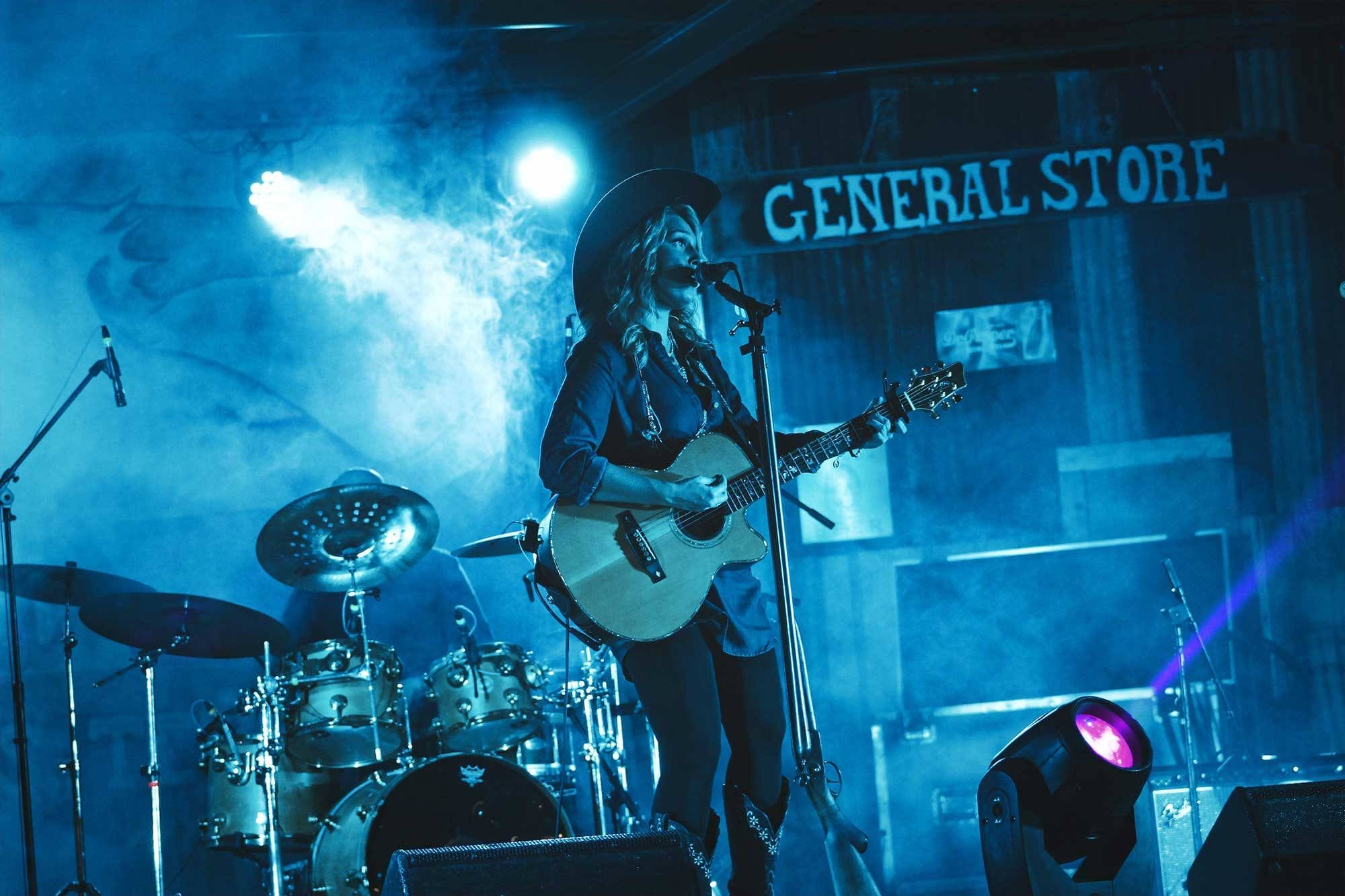 Female country singer singing and playing guitar