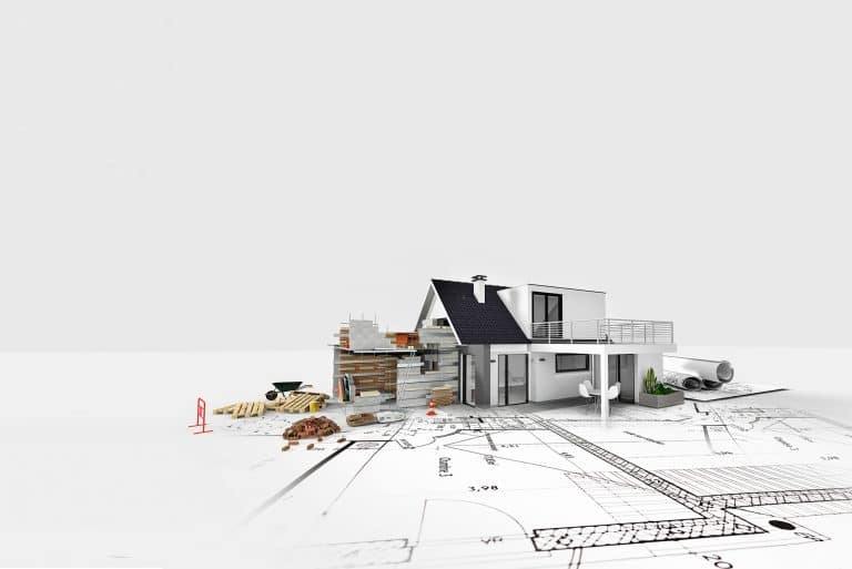 A white house on top of blueprints for building plans.