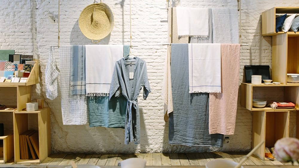 Household products hang on a wall and sit in shelves.