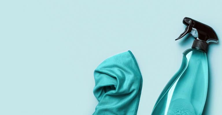 cleaning product in spray bottle and rag