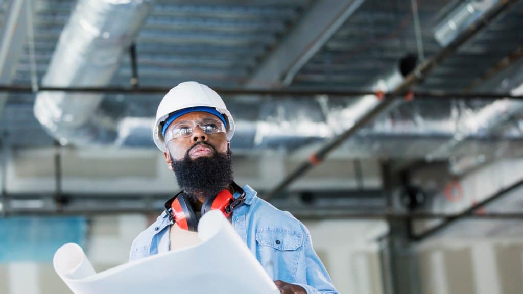 A general contractor reviews plans on a construction site.