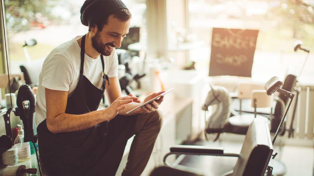 Salon owner looking at tablet