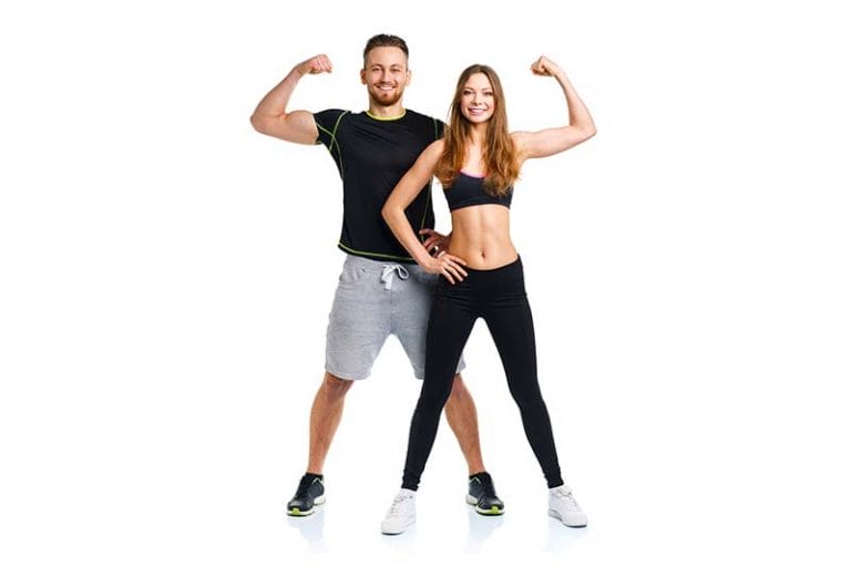 Two personal trainers pose and flex.