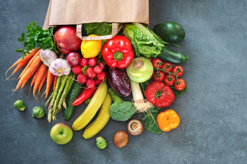 Assorted Vegetables and a brown paper bag.