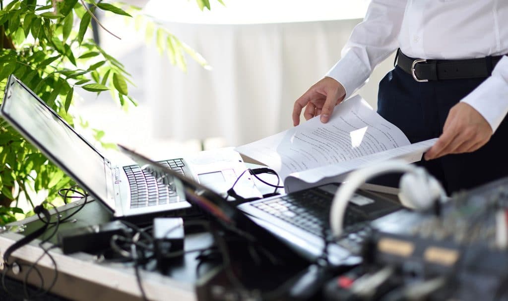 DJ table with laptop and wedding texts