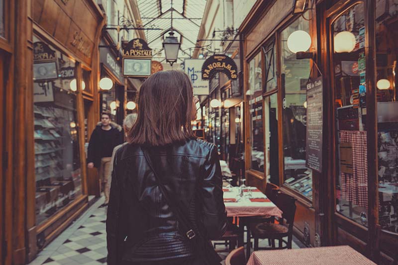 A customer walking through indoor shops.