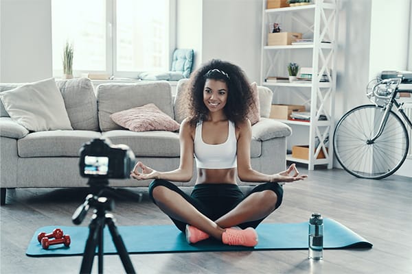 A yoga instructor has marketed her class well. It's full of students and she's insured with yoga insurance.