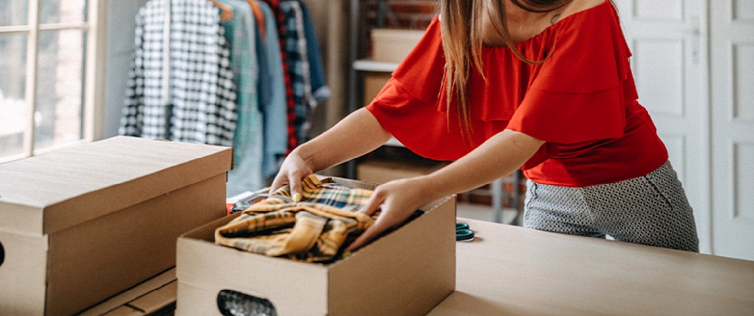 A woman packs products into a box.