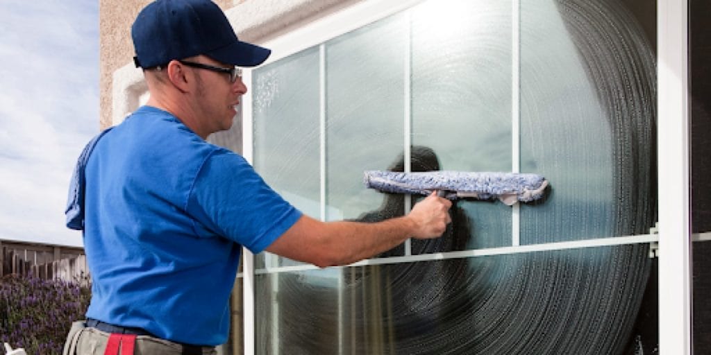 man washing an outdoor window