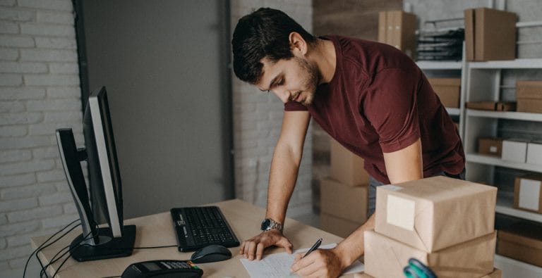 A man prepares his products for shipping.