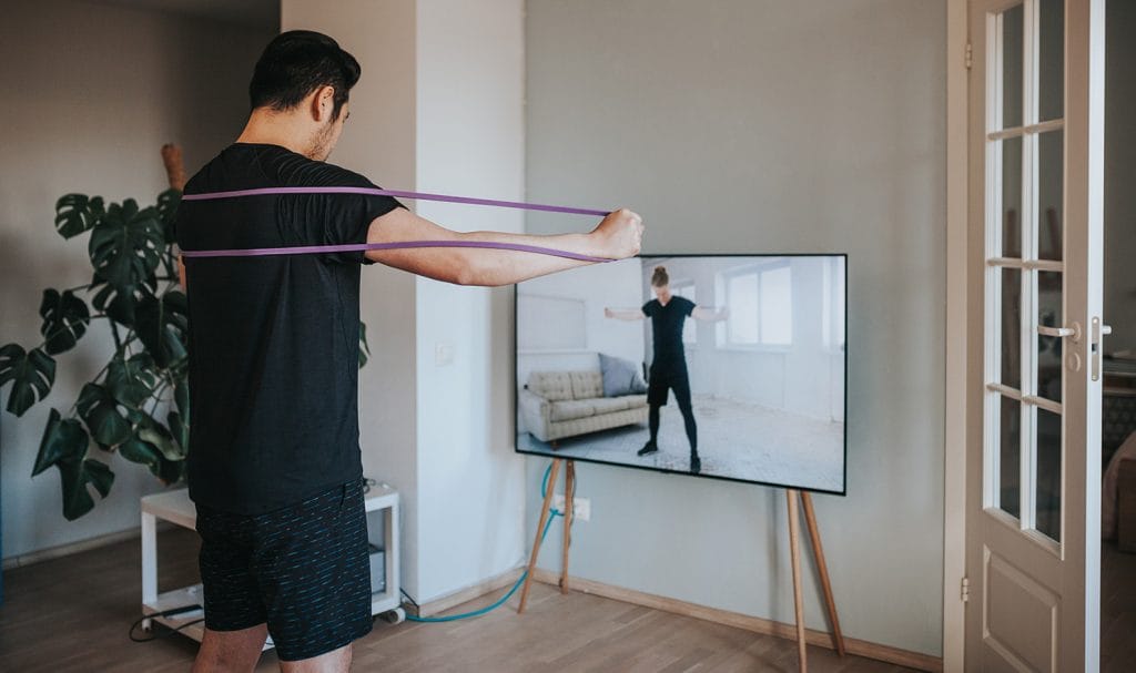 An online fitness client is using an arm band to