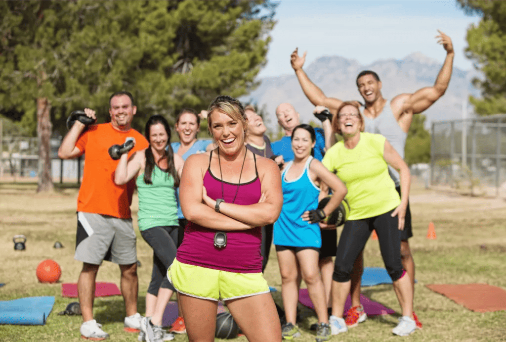 A jovial fitness group outside after a hard workout