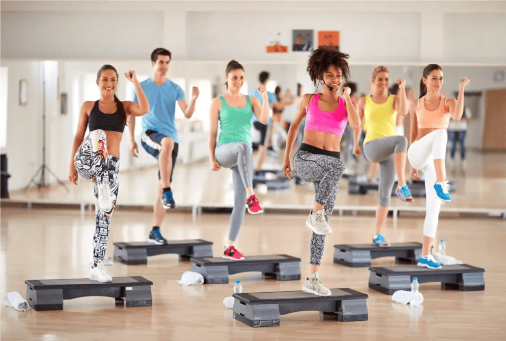 A high energy workout class, stepping onto a platform