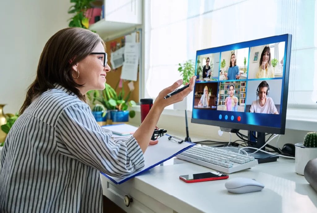 Online tutor teaching a group session in a video call.