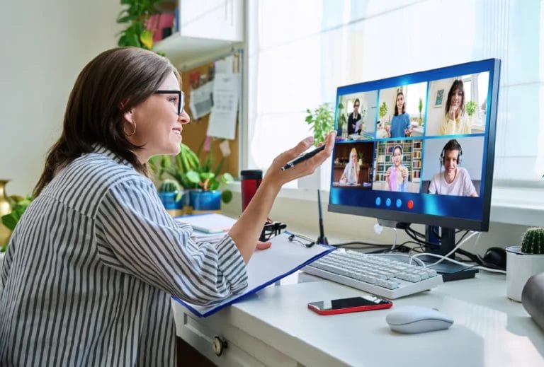 Online tutor teaching a group session in a video call.