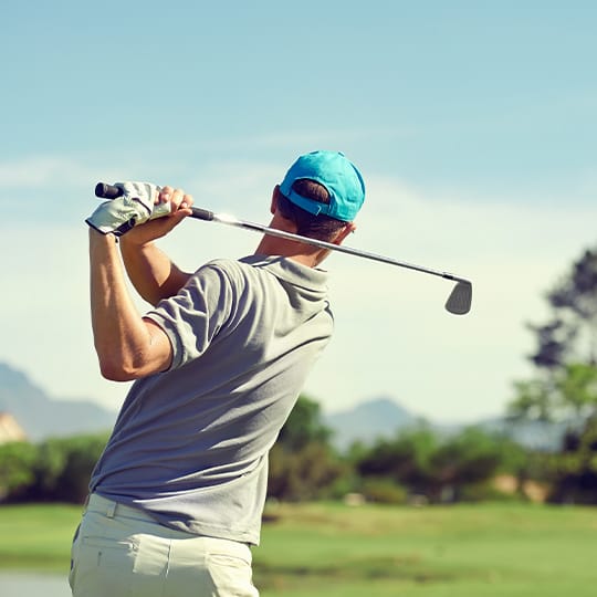 A golf instructor demonstrates a swing.