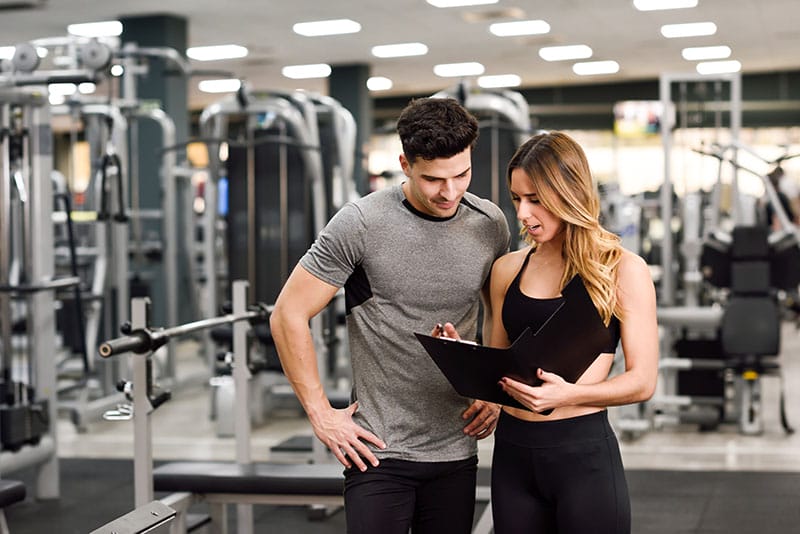 A fitness instructor trains an athlete.