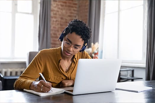 teacher studying with laptop and notebook