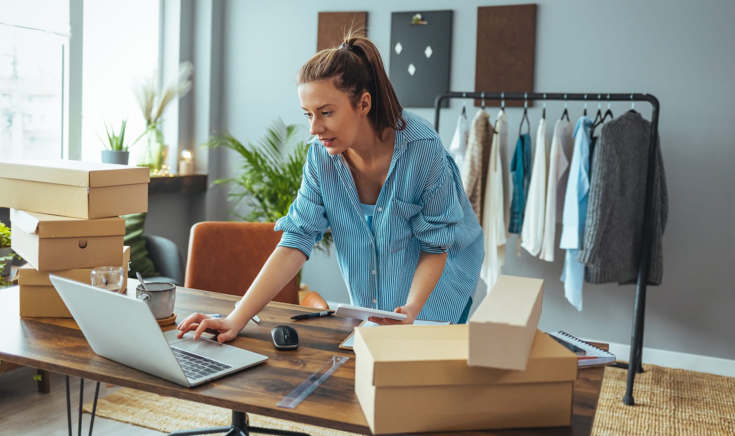 A woman packs products for shipping.