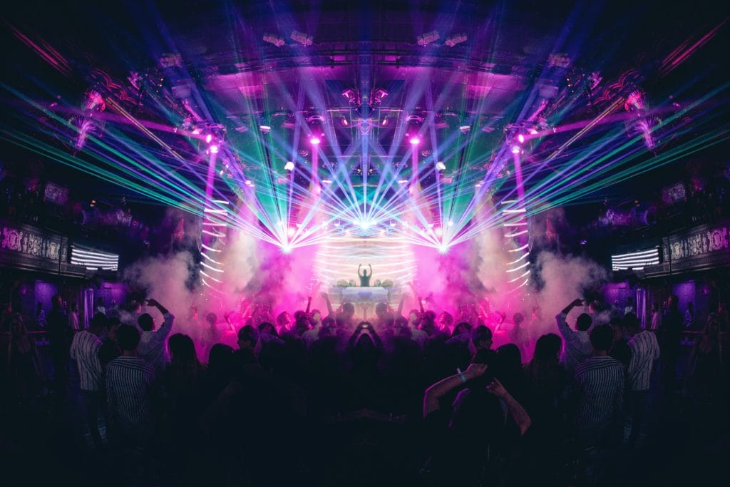 DJ show with lasers and people dancing