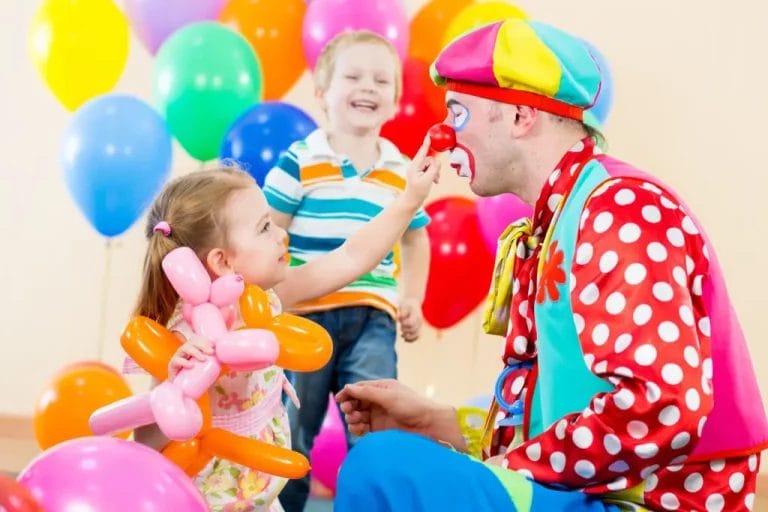 happy children and clown at birthday party