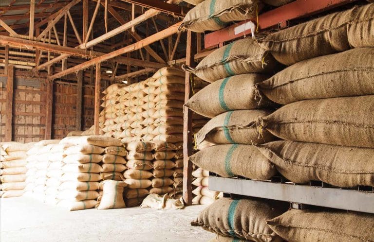 a stack of wholesale products in burlap sacks.