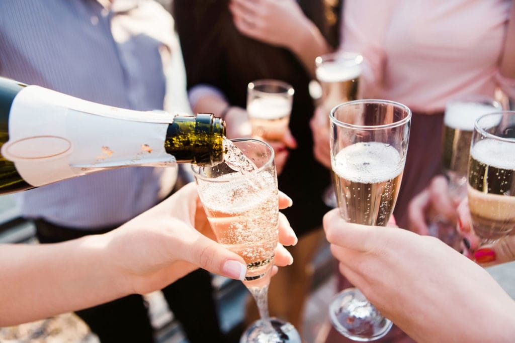 A group of friends holding champagne flutes, symbolizing a moment of joy and shared celebration.