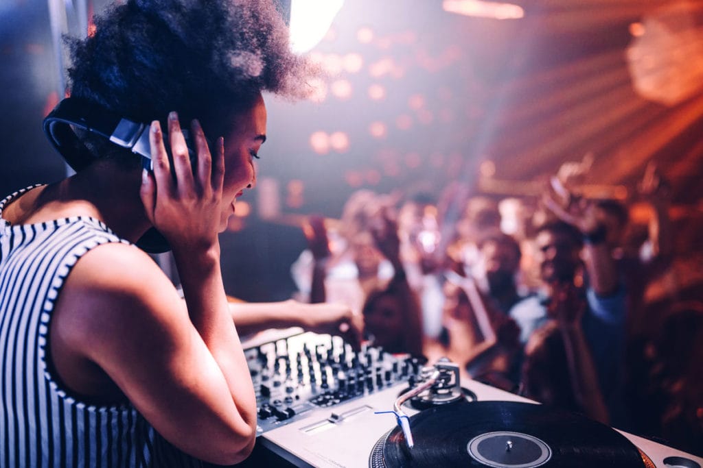 woman playing at small dj event