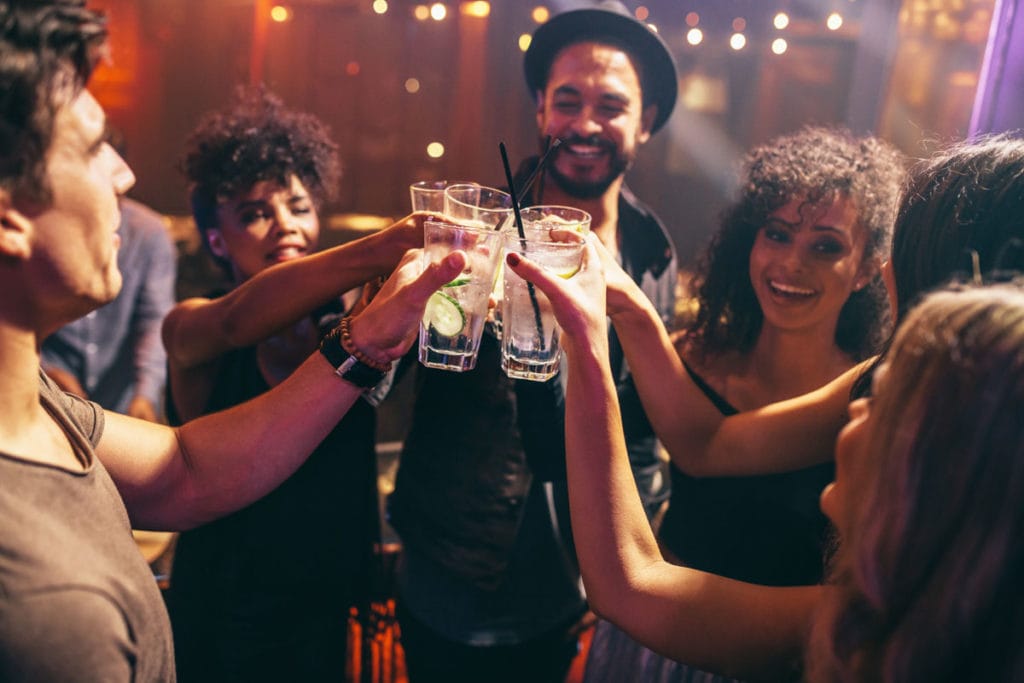 Group of people clinking glasses at party