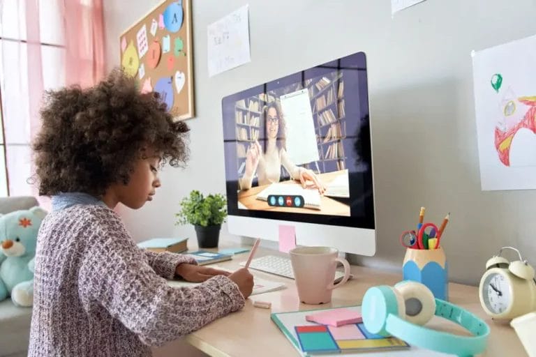 School aged girl learning from online tutor