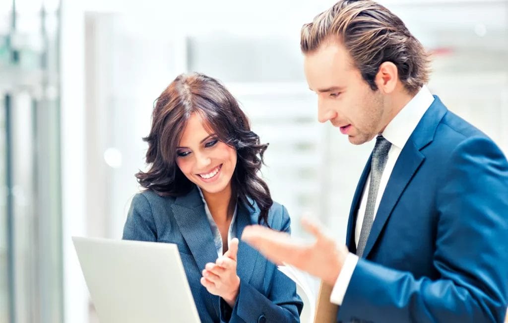 Two individuals looking at a business report.