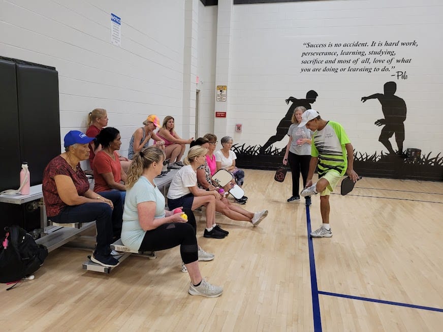 Ram giving a safety lesson and teaching students about the right shoes to wear on the court to stay safe.