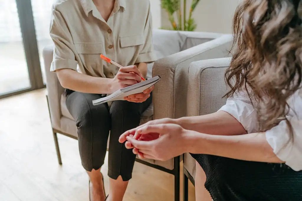 Two people sitting in a life coach counseling session