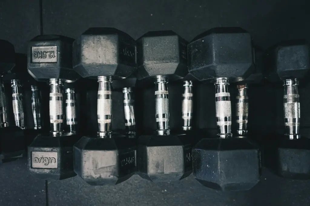 Row of dumbbells sitting on black mat