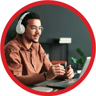 A tutor with headphones speaking on an online video call.