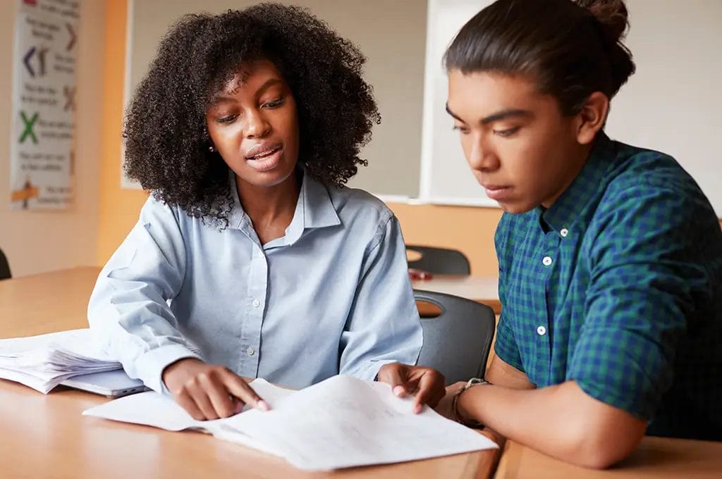 Private tutor and student in a lesson looking at paperwork