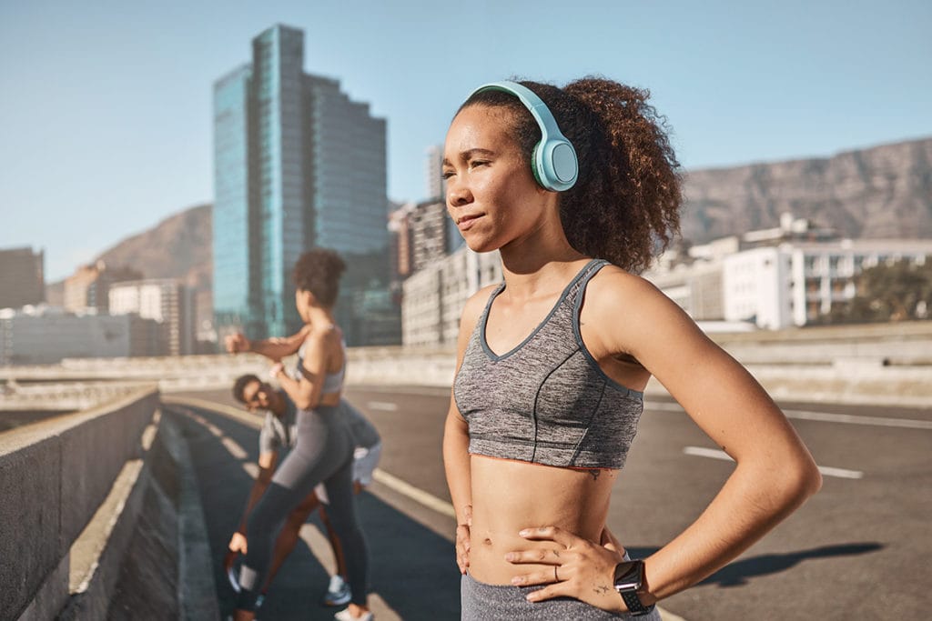 a group of runners prepares for a daytime jog.