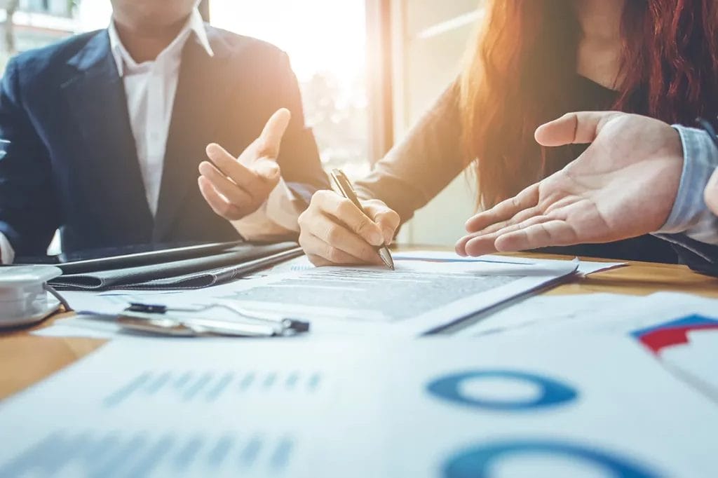 Business consultants in a meeting with various paperwork on the table