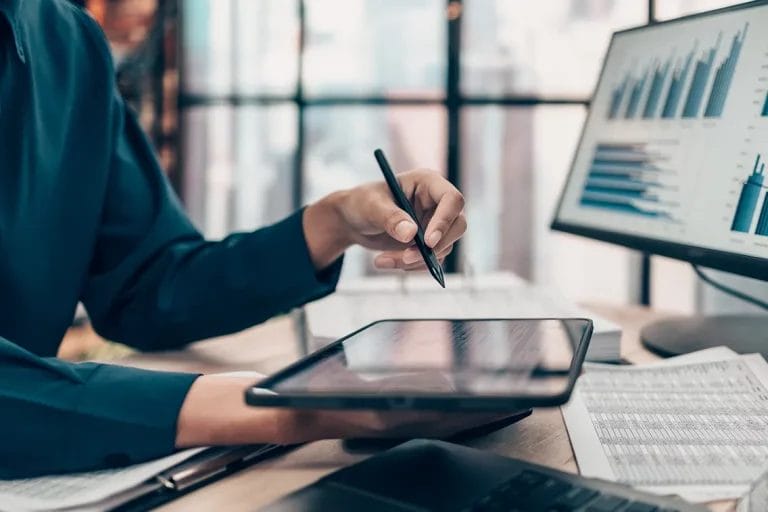 Consultant researching information on a tablet with a stylus in their hand.