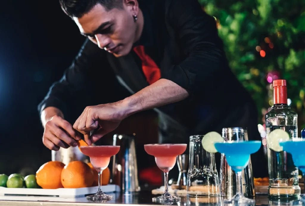 Mobile bartender pours martinis at outdoor event