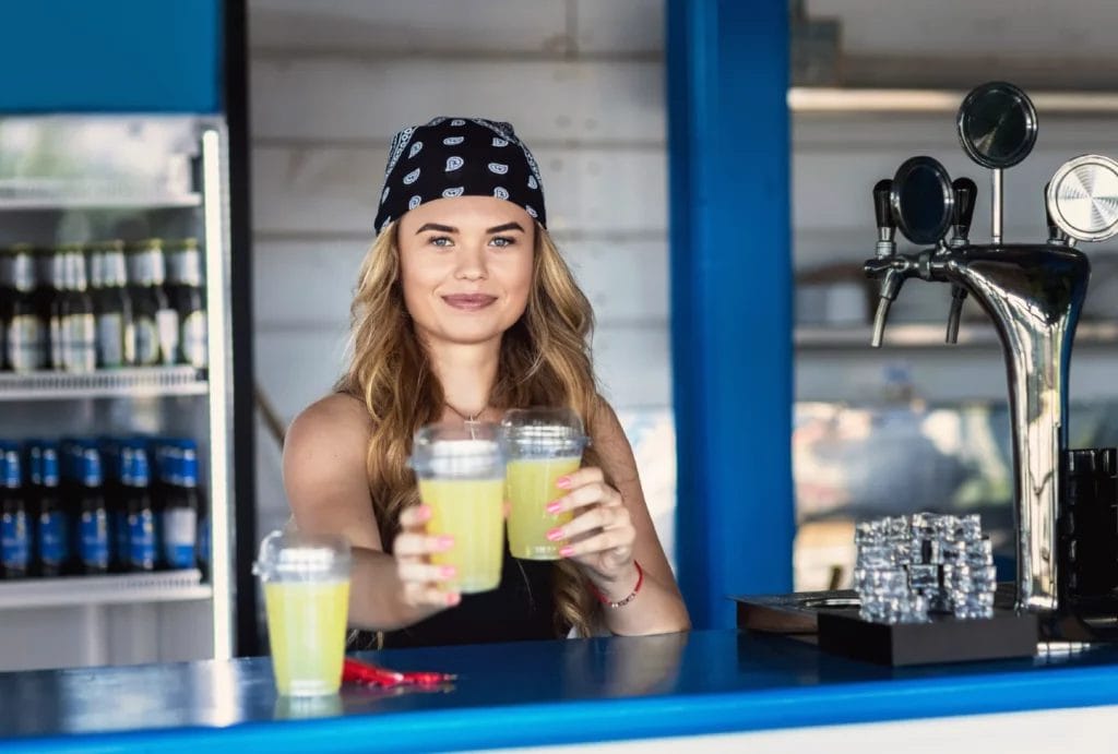 Mobile bartender mixing cocktails at outdoor bar