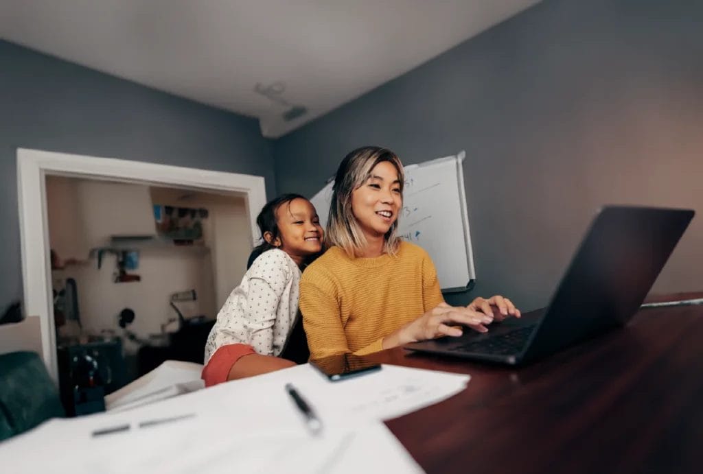 Happy mother and daughter looking at a computer together