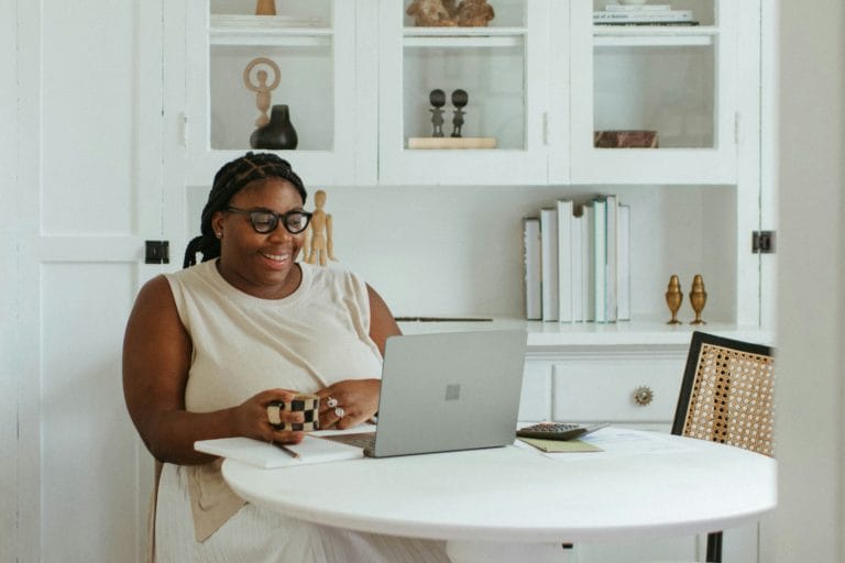 sitting woman happy at computer