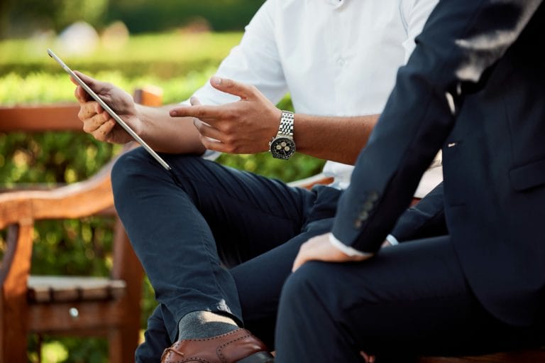 two men sitting on a bench