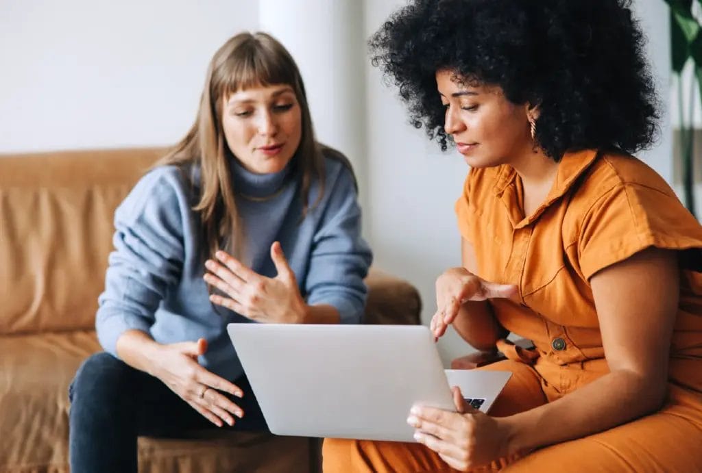 Life coach in a session with client, looking at a laptop